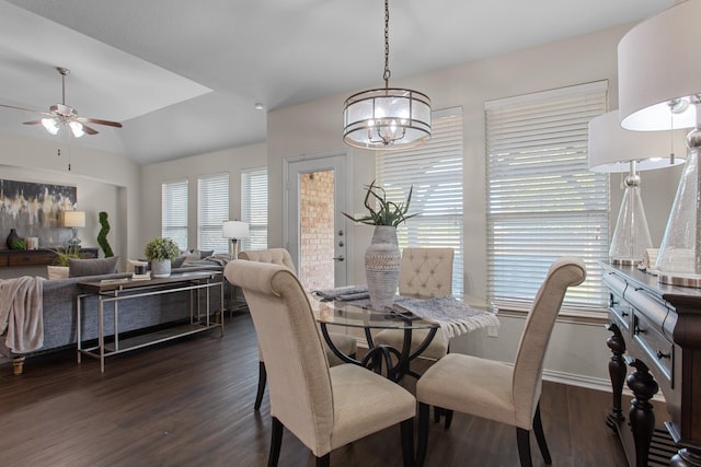 dining room with vaulted ceiling, ceiling fan, and dark wood-type flooring