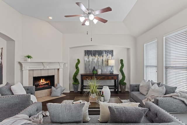 living room with ceiling fan, a fireplace, lofted ceiling, and hardwood / wood-style flooring