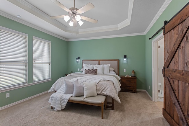 bedroom with a raised ceiling, crown molding, ceiling fan, a barn door, and light colored carpet