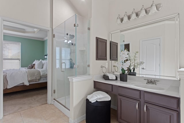 bathroom with vanity, tile patterned floors, a shower with door, and crown molding