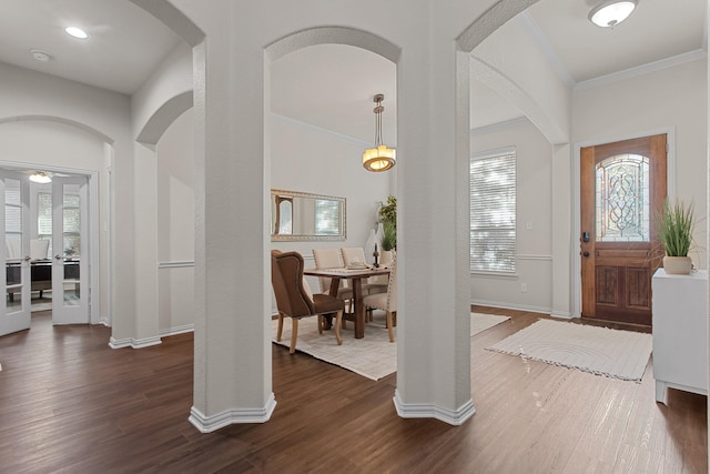 foyer entrance featuring dark hardwood / wood-style flooring and ornamental molding