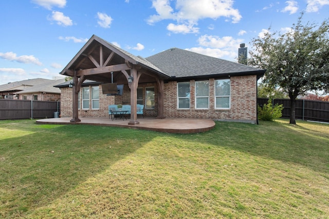 rear view of house with a patio and a lawn