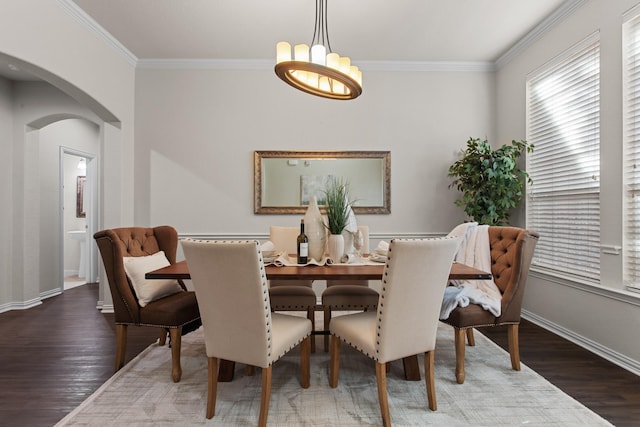 dining area featuring dark hardwood / wood-style flooring and ornamental molding