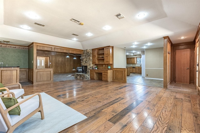 living room with wood-type flooring and vaulted ceiling