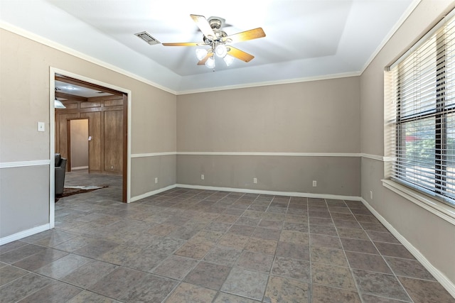 empty room featuring ornamental molding and ceiling fan