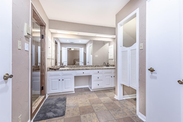 bathroom with vanity and an enclosed shower