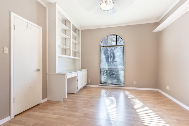 interior space with crown molding and light hardwood / wood-style floors