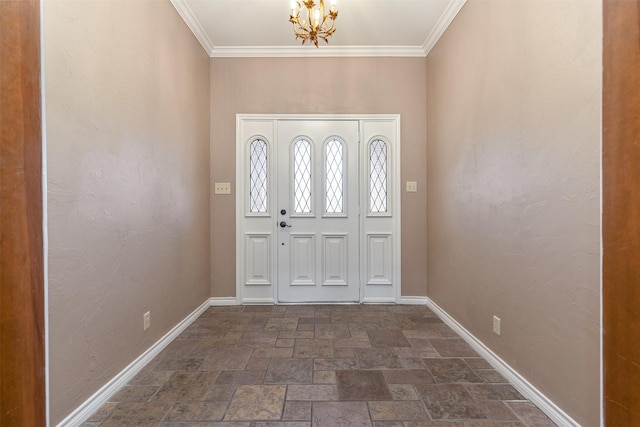 foyer with an inviting chandelier and crown molding