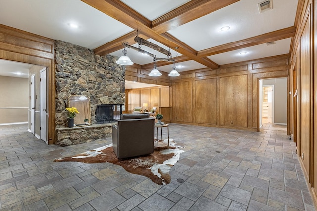 unfurnished living room featuring a fireplace, beam ceiling, and wood walls