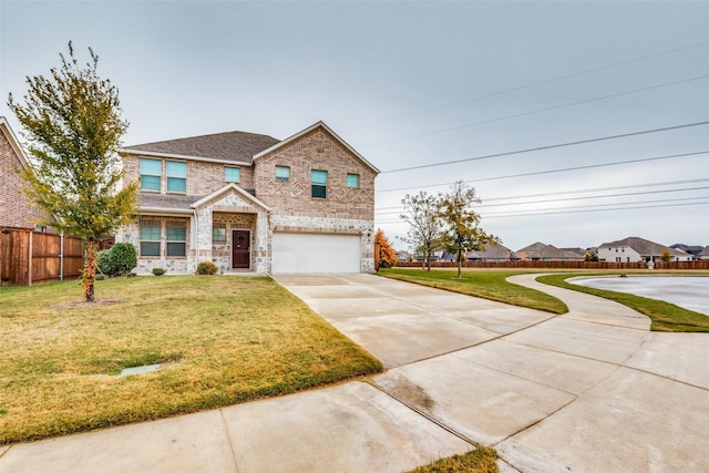 view of front of property with a front yard and a garage