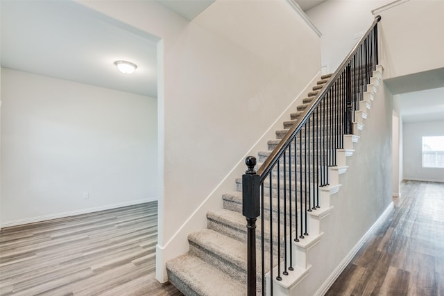 stairway with hardwood / wood-style flooring