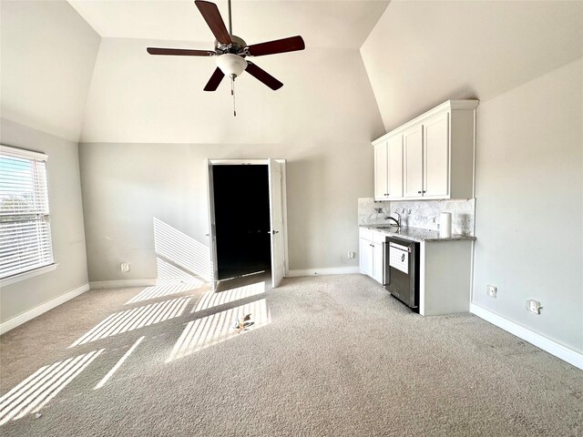 interior space with light carpet, high vaulted ceiling, ceiling fan, and sink