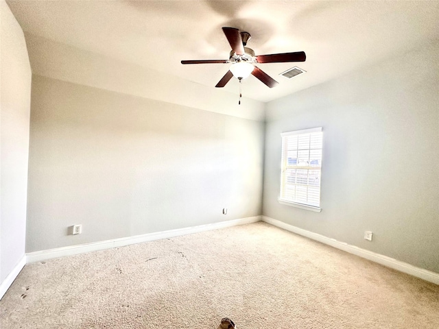 empty room with ceiling fan and carpet floors