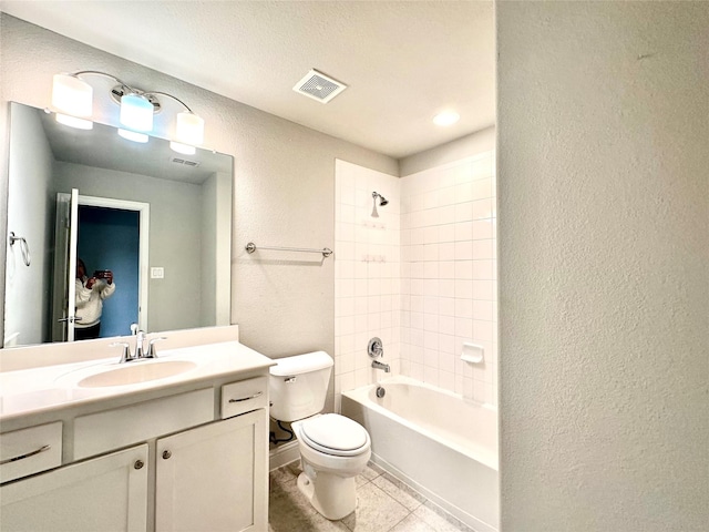 full bathroom featuring toilet, vanity, tiled shower / bath combo, and tile patterned flooring