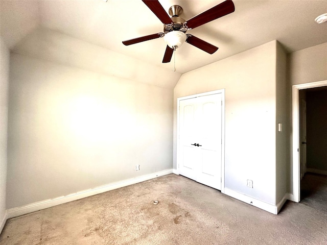 unfurnished bedroom with ceiling fan, carpet, and lofted ceiling