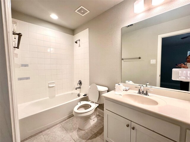 full bathroom featuring vanity, toilet, and tiled shower / bath