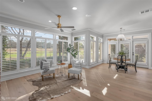 sunroom featuring ceiling fan