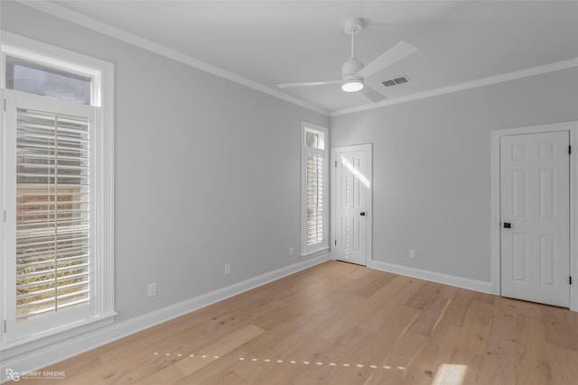 spare room with ornamental molding, ceiling fan, and light hardwood / wood-style flooring