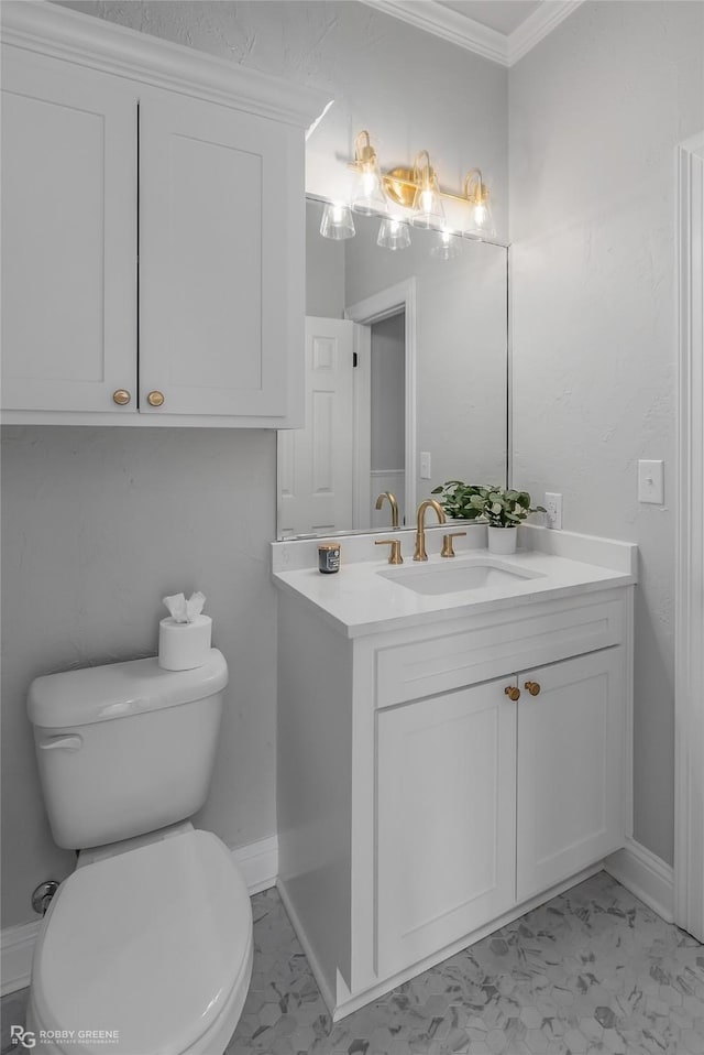 bathroom featuring ornamental molding, vanity, and toilet