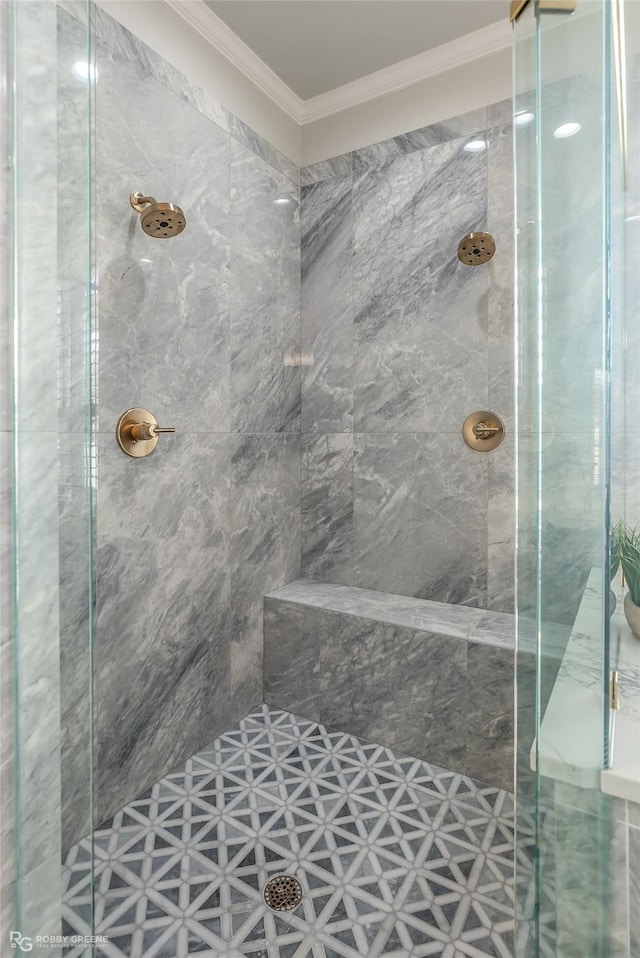 bathroom featuring ornamental molding and a tile shower