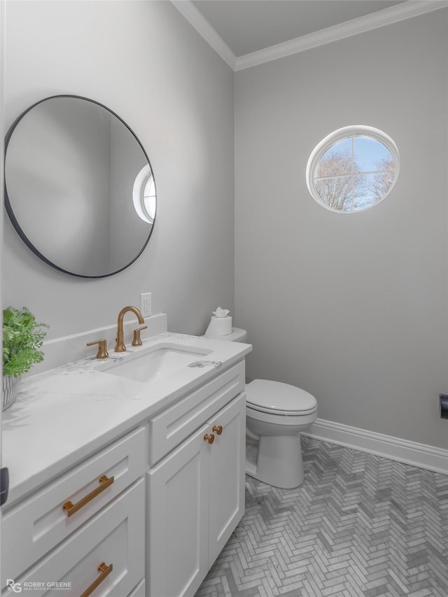 bathroom with vanity, ornamental molding, and toilet