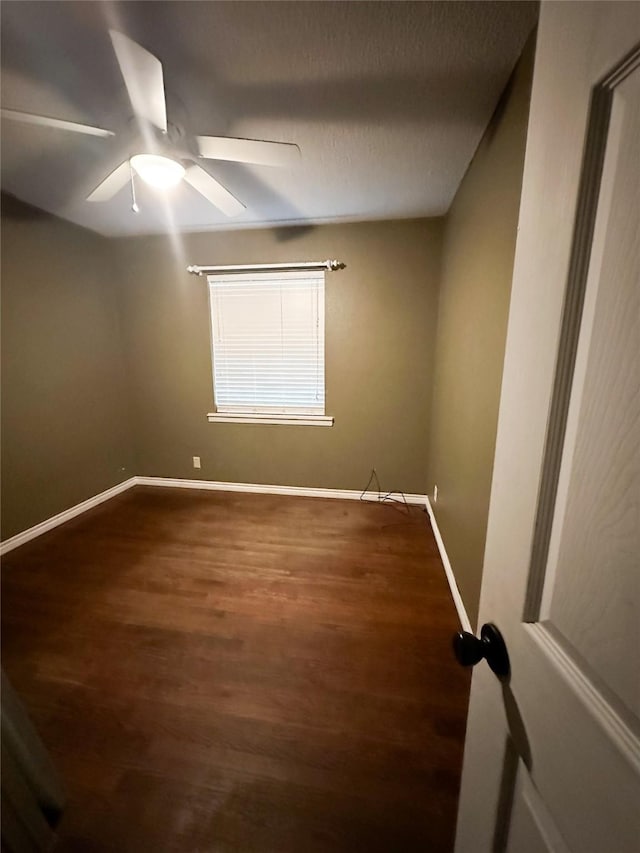 spare room featuring ceiling fan, dark hardwood / wood-style flooring, and a textured ceiling