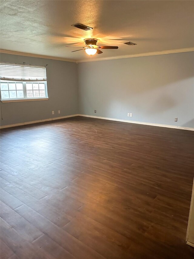 spare room with a textured ceiling, dark hardwood / wood-style flooring, ceiling fan, and ornamental molding