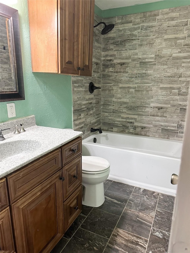 full bathroom featuring vanity, toilet, and tiled shower / bath