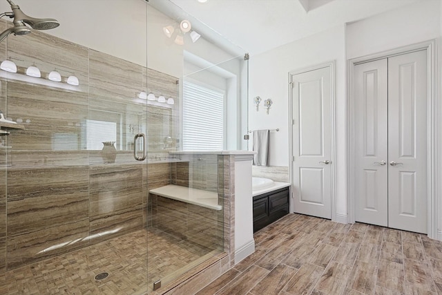 bathroom featuring wood-type flooring and independent shower and bath