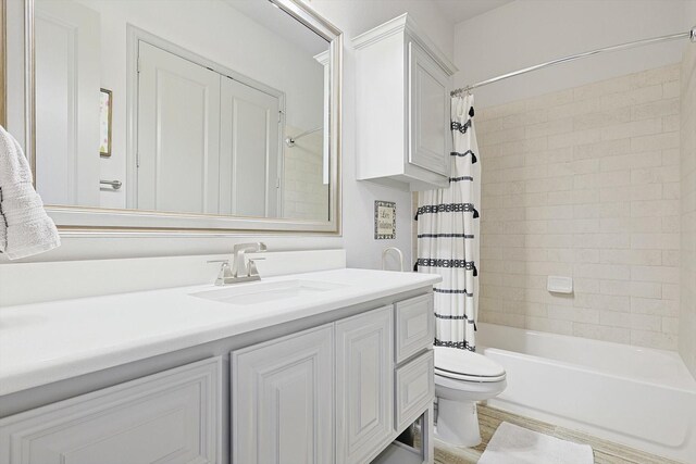 full bathroom featuring vanity, toilet, and shower / tub combo