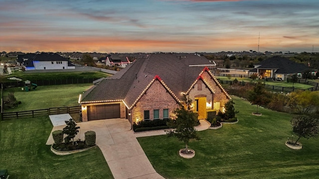 view of front of house featuring a garage and a yard