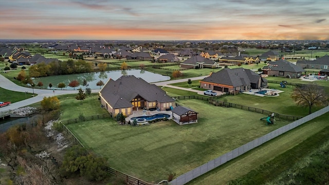 aerial view at dusk with a water view