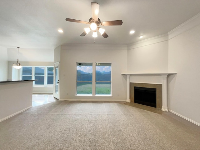 unfurnished living room with ceiling fan, light colored carpet, and ornamental molding