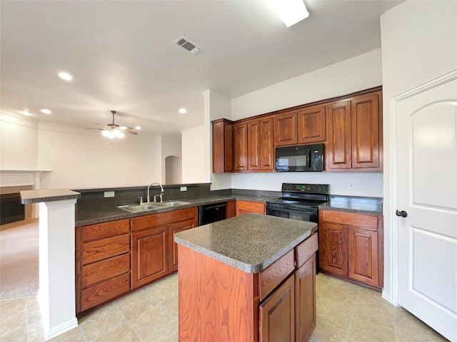 kitchen with a center island, black appliances, sink, ceiling fan, and kitchen peninsula