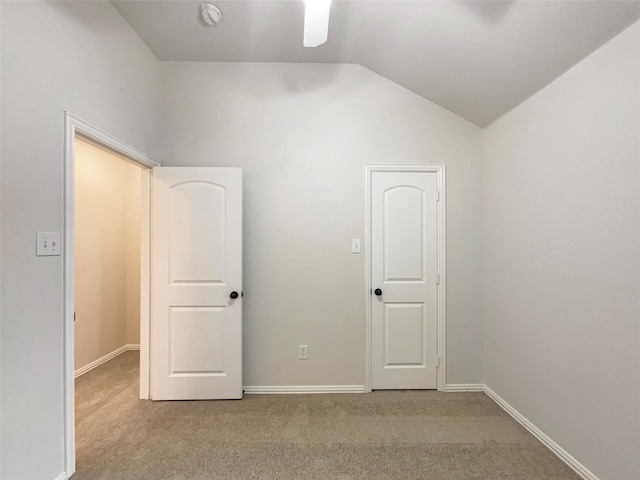 unfurnished bedroom with ceiling fan, light colored carpet, and lofted ceiling