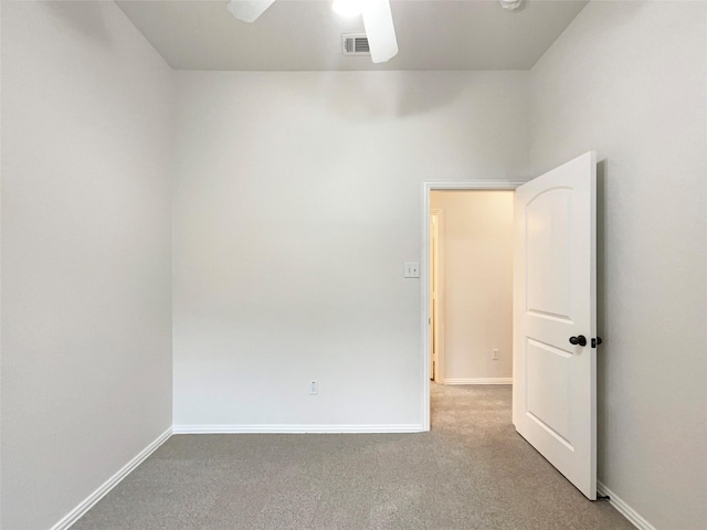 carpeted spare room with ceiling fan