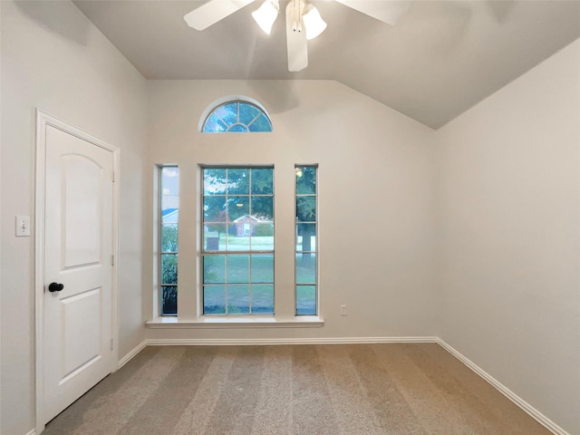 carpeted empty room featuring ceiling fan and lofted ceiling