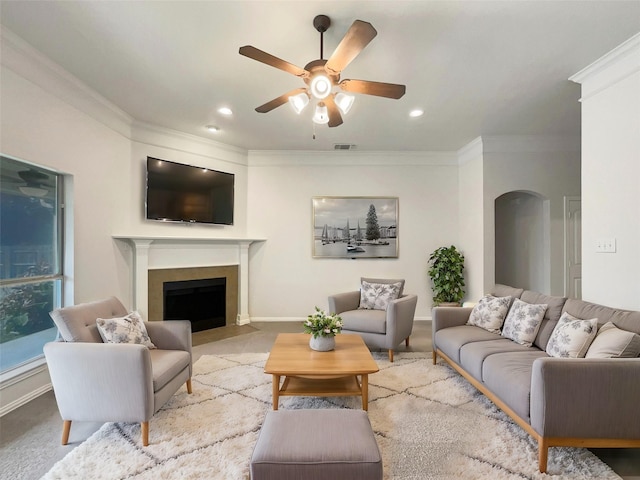 living room featuring crown molding and ceiling fan