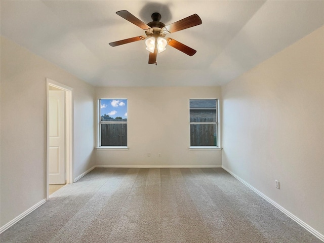 spare room with light colored carpet and ceiling fan