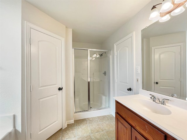 bathroom featuring tile patterned flooring, vanity, and a shower with door