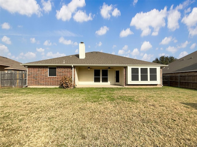 back of house with a patio area, ceiling fan, and a yard