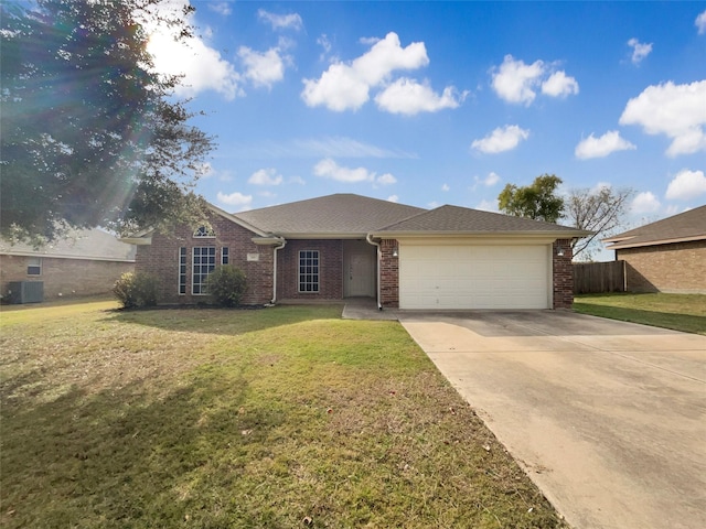 ranch-style house featuring cooling unit, a front yard, and a garage