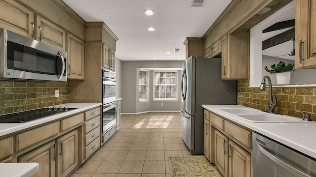 kitchen featuring decorative backsplash, appliances with stainless steel finishes, light tile patterned floors, and sink