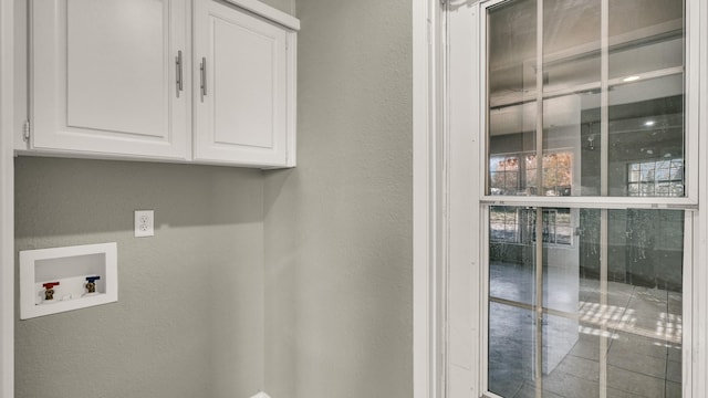 clothes washing area with cabinets and hookup for a washing machine