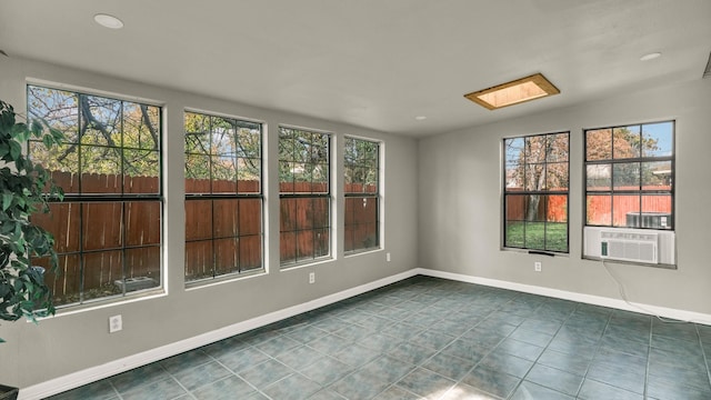 tiled empty room with a skylight and cooling unit