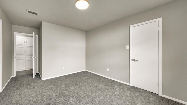 unfurnished bedroom featuring dark carpet