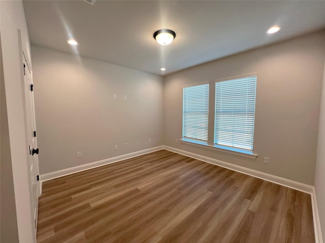 unfurnished room with dark wood-type flooring