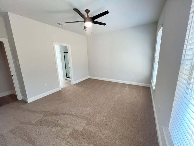 carpeted empty room with ceiling fan