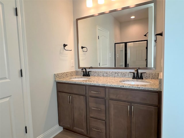 bathroom with vanity and a shower with shower door