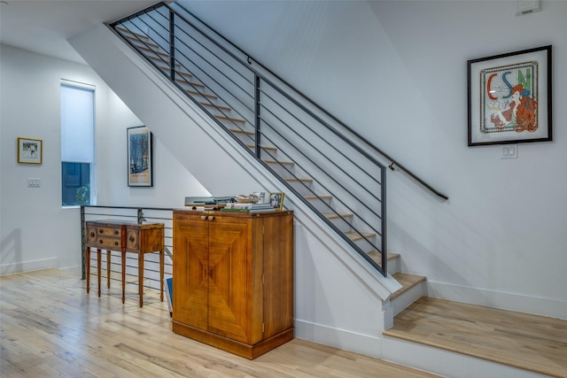 stairs with hardwood / wood-style flooring